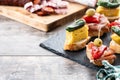 Traditional Spanish pintxos on wooden table Royalty Free Stock Photo