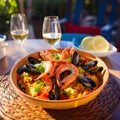 Traditional spanish seafood paella in the fry pan on a wooden table