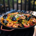 Traditional spanish seafood paella in the fry pan on a wooden table