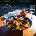Traditional spanish seafood paella in the fry pan on a wooden table