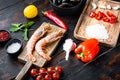 Traditional spanish seafood paella ingredients on old wooden dark table