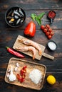 Traditional spanish seafood paella ingredients on old wooden dark table, top view