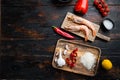 Traditional spanish seafood paella ingredients on old wooden dark table, top view with space for text