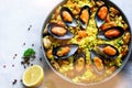 Traditional spanish seafood paella in pan rice, peas, shrimps, mussels, squid on light grey concrete background. Top Royalty Free Stock Photo