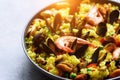 Traditional spanish seafood paella in pan rice, peas, shrimps, mussels, squid on light grey concrete background. Top Royalty Free Stock Photo