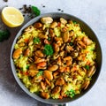 Traditional spanish seafood paella in pan rice, peas, shrimps, mussels, squid on light grey concrete background. Top Royalty Free Stock Photo