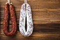 Traditional spanish smoked sausages meat hanging on light wooden background with copy space Royalty Free Stock Photo