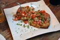 Traditional spanish tapas on a plate. Bruschetta on crusty bread with cheese,tomato,onion and parsley