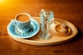 Traditional sparkling turkish coffee served with porcelain cup, cookies, glass of water and flower Royalty Free Stock Photo