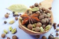 Traditional spices in a wooden spoon. Anise star, allspice, cardamom, black pepper and bay leaf on a blue background Royalty Free Stock Photo