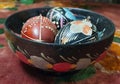 Traditional spring composition with painted Easter eggs lying in a wooden decorative bowl. Bright ornaments on the eggs Royalty Free Stock Photo
