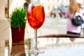 Traditional Spritz aperitif in a bar in Italy, glass of cocktail Aperol Spritz on table terrace of restaurant Royalty Free Stock Photo