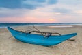 Traditional Sri Lankan fishing boat on sandy beach at sunset. Royalty Free Stock Photo