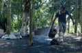 Traditional Sri Lankan Labour pouring tar to roads on 2022.12.12 at Galle, Sri Lanka