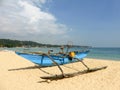 Outrigger fishing boat on beach Royalty Free Stock Photo