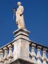 Traditional statue as a decoration on the roof of a classic house in Leiria