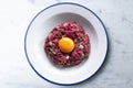 Traditional steak tartare with beef and egg yolk. Traditional Spanish tapas.