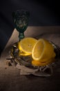 Traditional still life with lemon and a blue wineglass Royalty Free Stock Photo