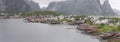 Traditional stilt rorbuer at Artic fjord inlet harbor, Reine, Lofoten, Norway