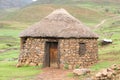 Traditional stone bungalow with straw roof without people