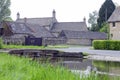 Cotswolds traditional village with stone houses, by a river Royalty Free Stock Photo