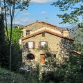 Traditional stone mountain house in green forest at Prats de Mollo la Preste, Pyrenees-Orientales in southern France Royalty Free Stock Photo