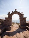 Traditional stone rock arch welcome entrance gate on Taquile Island walkway path Lake Titicaca Puno Peru South America