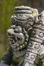 Traditional stone statue depicting demon, god and Balinese mythological deities in Ubud, island Bali, Indonesia , closeup