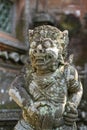 Traditional stone statue depicting demon, god and Balinese mythological deities in Ubud, island Bali, Indonesia . Stone statue