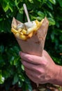 Traditional street food in Belgium and Netherlands, French fried potatoes chips with mayonnaise sauce in paper cone