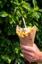 Traditional street food in Belgium and Netherlands, French fried potatoes chips with mayonnaise sauce in paper cone