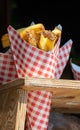 Traditional street food in Belgium and Netherlands, French fried potatoes chips with mayonnaise sauce in paper cone bag