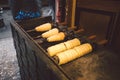 Traditional street food of country Czech Republic. Preparing of Trdelnik - traditional czech bakery. Czech sweet pastry called Trd