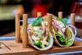 Traditional street mexican pork tacos with beef, tomatoes, avocado, chilli in yellow corn tortilla Royalty Free Stock Photo