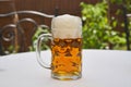 Traditional style half litre mug full of cold pilsner beer. Royalty Free Stock Photo