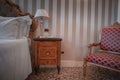 Traditional style hotel room at Hotel Venezia, Venice, Italy with tiled flooring and simple bed frames.