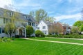 Traditional suburban homes with green front lawns Royalty Free Stock Photo