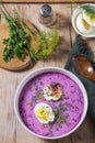 Traditional summer cold beetroot soup with cucumber, egg and sour cream on a wooden background. Rustic style. Royalty Free Stock Photo