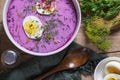 Traditional summer cold beetroot soup with cucumber, egg and sour cream on a wooden background. Rustic style. Royalty Free Stock Photo