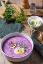 Traditional summer cold beetroot soup with cucumber, egg and sour cream on a wooden background. Rustic style. Royalty Free Stock Photo
