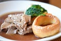 Traditional Sunday roast beef dinner with Yorkshire puddings and gravy
