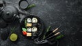 Traditional Sushi - Black and White, with crab, cheese and herbs. Japanese cuisine.