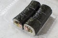 Traditional Sushi roll with salmon, nori and vegetables in plastic container for take away