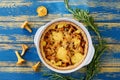 Traditional swedish chanterelle mushrooms tart - quiche with cheese and herbs in the baking dish decorated with fresh rosemary Royalty Free Stock Photo