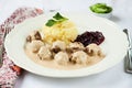 Traditional Swedish meatballs with mashed potatoes and red bilberry jam