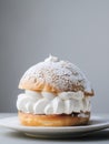 Traditional Swedish Semla bun on gray background with copy space. Delicious pastry with whipped cream. Generative AI Royalty Free Stock Photo