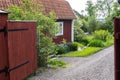Traditional Swedish wooden house. Countryside village in Scandinavia. Red typical cottage rural house. Entrance open. Old wooden Royalty Free Stock Photo