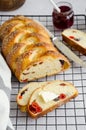 Traditional sweet Easter bread with raisins, dried cherries with jam and butter on a light background. Cozonac Royalty Free Stock Photo