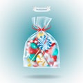 Traditional sweets candies lollipop and Candy Cane packed in a transparent sachet package with a red ribbon on blue