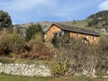 Traditional Swiss architecture and wooden alpine houses in the autumn environment of mountain pastures and mixed forests Royalty Free Stock Photo